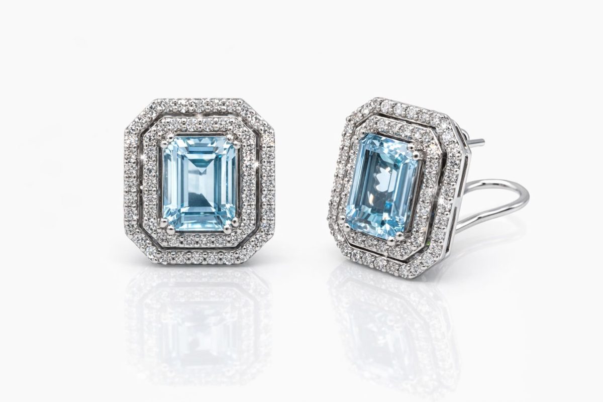 Exquisite 18ct white gold earrings featuring emerald‑cut aquamarine gemstones surrounded by double halos of sparkling round brilliant‑cut diamonds, featuring stud clips for safe wearing.