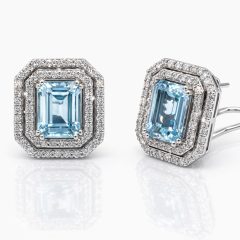 Exquisite 18ct white gold earrings featuring emerald‑cut aquamarine gemstones surrounded by double halos of sparkling round brilliant‑cut diamonds, featuring stud clips for safe wearing.
