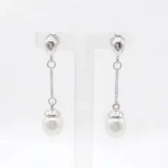 A pair of sterling silver drop Freshwater Pearl earrings featuring small, polished teardrop-shaped studs at the top. A delicate silver chain hangs from each stud, ending in a round white pearl topped with a small silver cap. With push on butterflies.