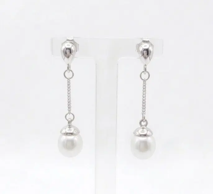 A pair of sterling silver drop Freshwater Pearl earrings featuring small, polished teardrop-shaped studs at the top. A delicate silver chain hangs from each stud, ending in a round white pearl topped with a small silver cap. With push on butterflies.