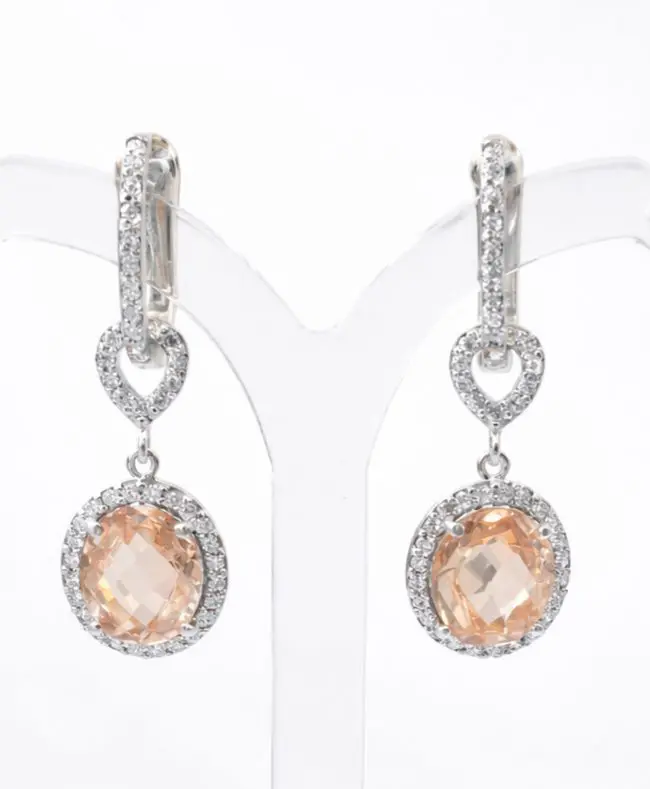 Elegant sterling silver pretty woman earrings featuring pave-set stud clip and pear-shaped links, finished with oval peach-toned cubic zirconia stones surrounded by sparkling white cubic zirconia halos.