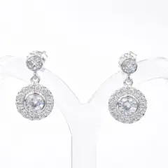 Elegant sterling silver drop earrings featuring round cubic zirconia studs with halo-set dangling discs. With push on butterflies.