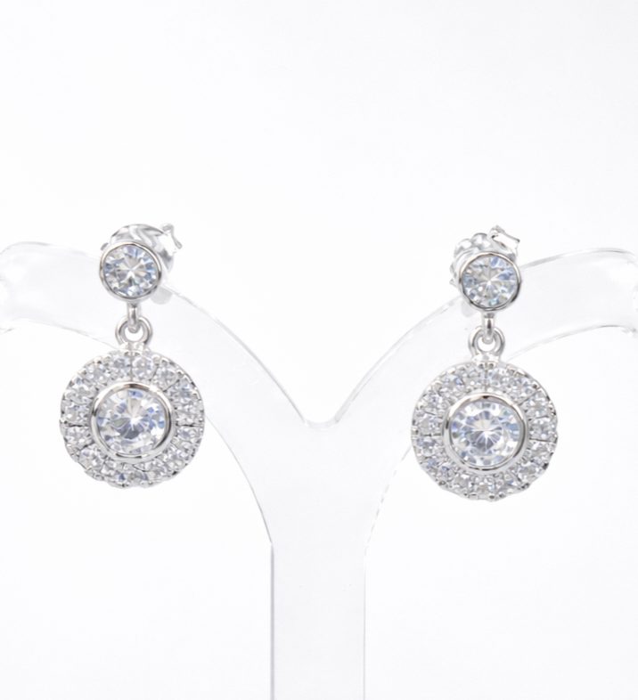 Elegant sterling silver drop earrings featuring round cubic zirconia studs with halo-set dangling discs. With push on butterflies.