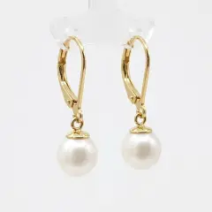 A pair of elegant drop earrings featuring drop, creamy white freshwater pearls suspended from delicate gold plated French hooks.