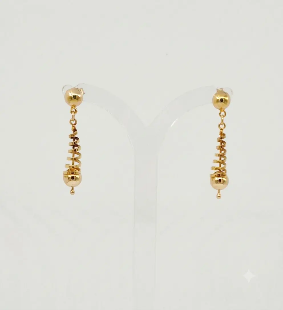 A pair of polished 9ct yellow gold dangle earrings. Each earring features a small gold bead at the top, leading to tapered, spiral-shaped center section that ends with a larger smooth gold sphere and a tiny accent bead at the very bottom.