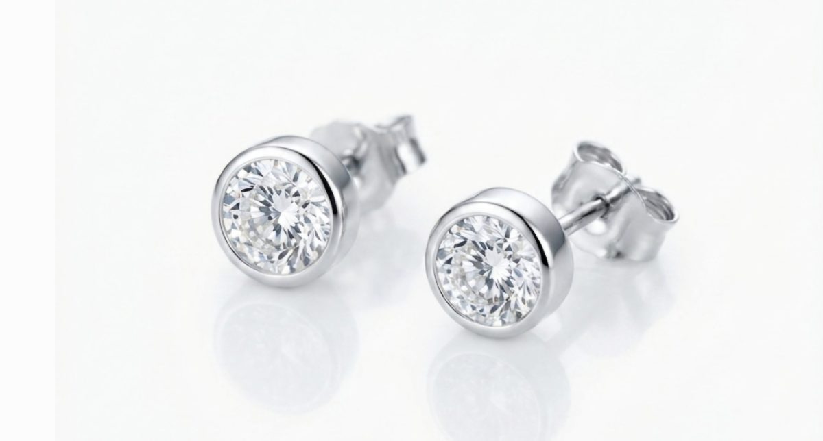 Fiera A pair of classic round-cut stud earrings set in polished 9ct White gold bezel, with push on butterflies.
