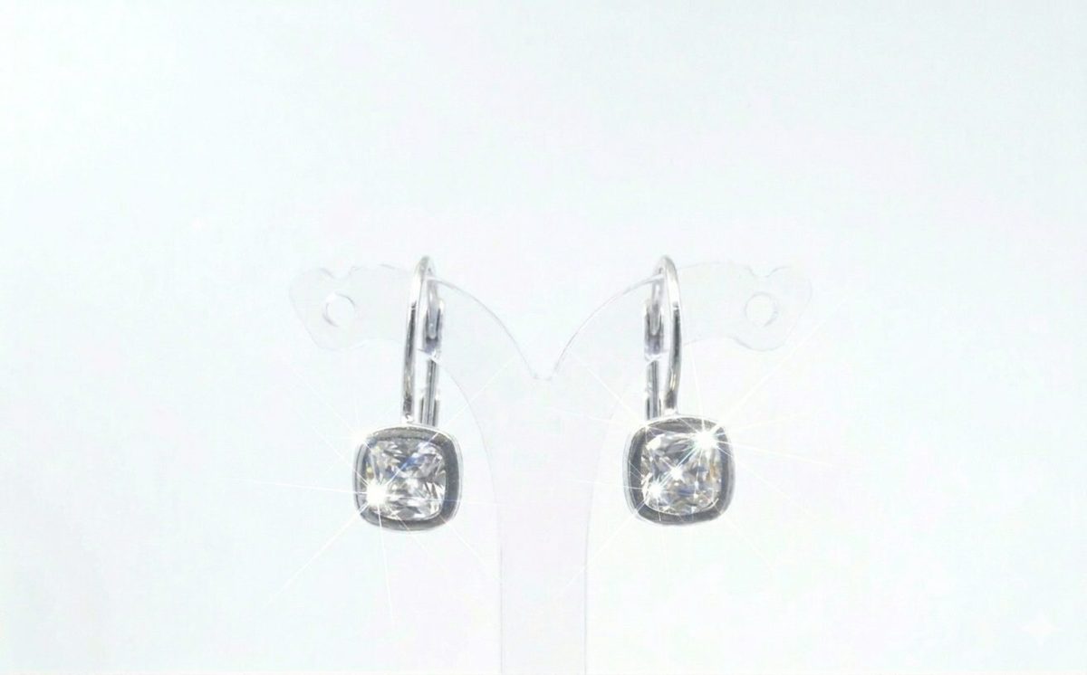 A pair of silver-toned drop earrings with cushion-cut cubic zirconia stones.