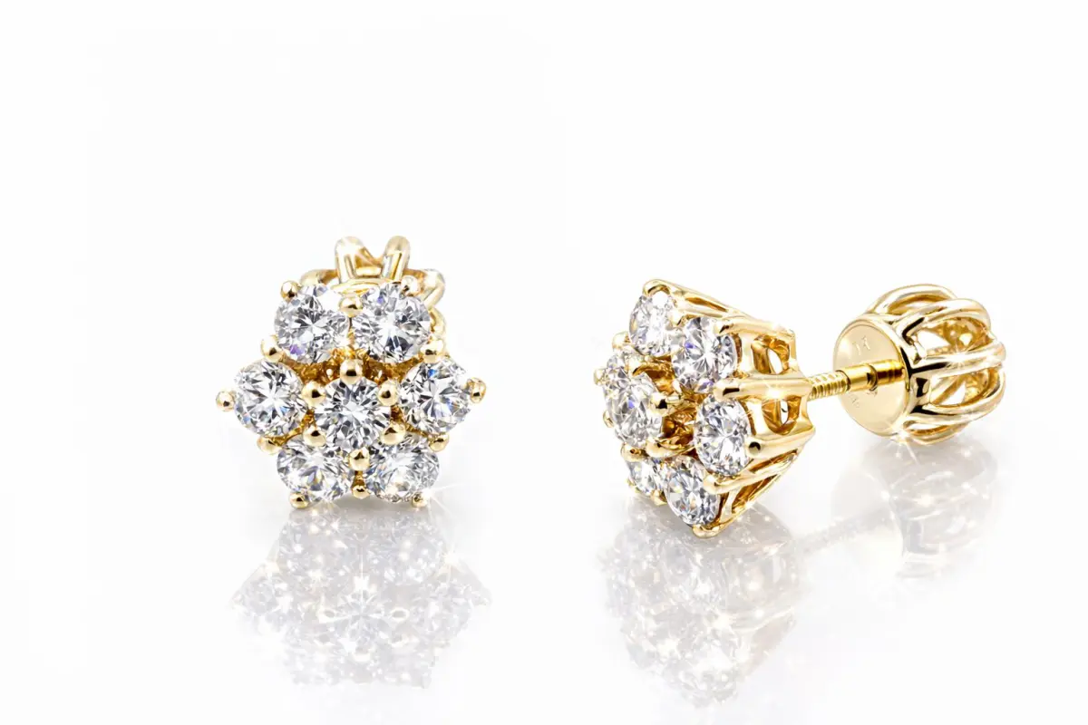 20210422_144228Flore Pair of 9ct yellow gold diamond cluster stud earrings displayed on a pristine white background. Each earring features seven round brilliant-cut diamonds arranged in a floral pattern, radiating icy sparkle and clarity. The polished gold prongs and screw-back posts gleam softly, enhancing the luxurious, luminous presentation.”