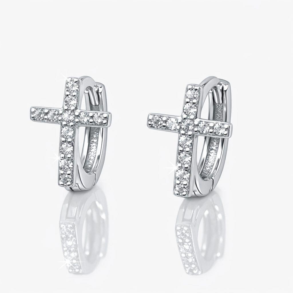 Pair of sterling silver huggie hoop earrings featuring cross motifs encrusted with brilliant cubic zirconia stones.