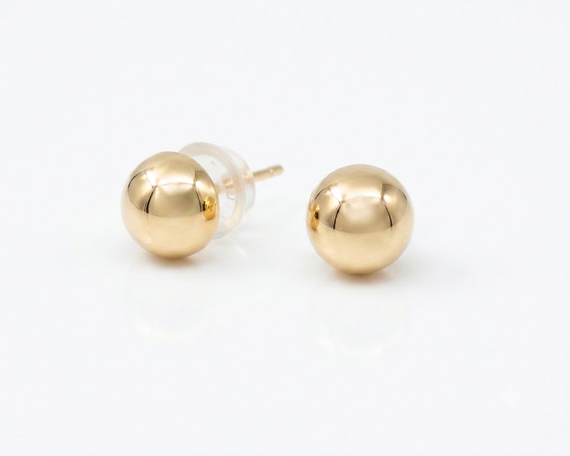 These classic 9ct Yellow Gold Half-Ball Stud Earrings with Silicone-Encased Butterfly Backs feature a timeless versatile design.