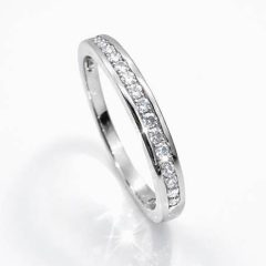 Sterling silver half‑eternity ring featuring a row of sparkling cubic zirconia stones set in a sleek channel design, displayed against a clean white background.