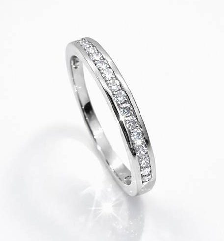 Sterling silver half‑eternity ring featuring a row of sparkling cubic zirconia stones set in a sleek channel design, displayed against a clean white background.