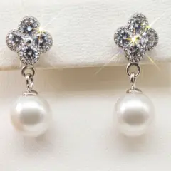 Elegant silver dangling earrings with radiant, shimmering CZ clover tops and round white freshwater pearls, with push on butterflies.
