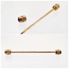 An 18ct yellow gold collar pin featuring two vibrant cabochon rubies totaling 0.50ct, accented by 12 sparkling round diamonds totaling 0.25ct, secured with a roll-on fastening.