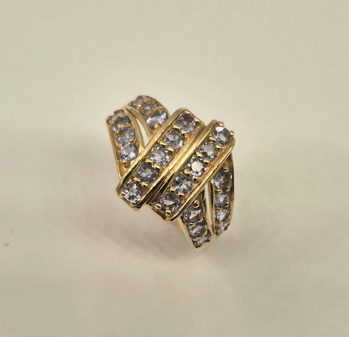 A large, intricate gemstone dress ring with a central blue sapphire.