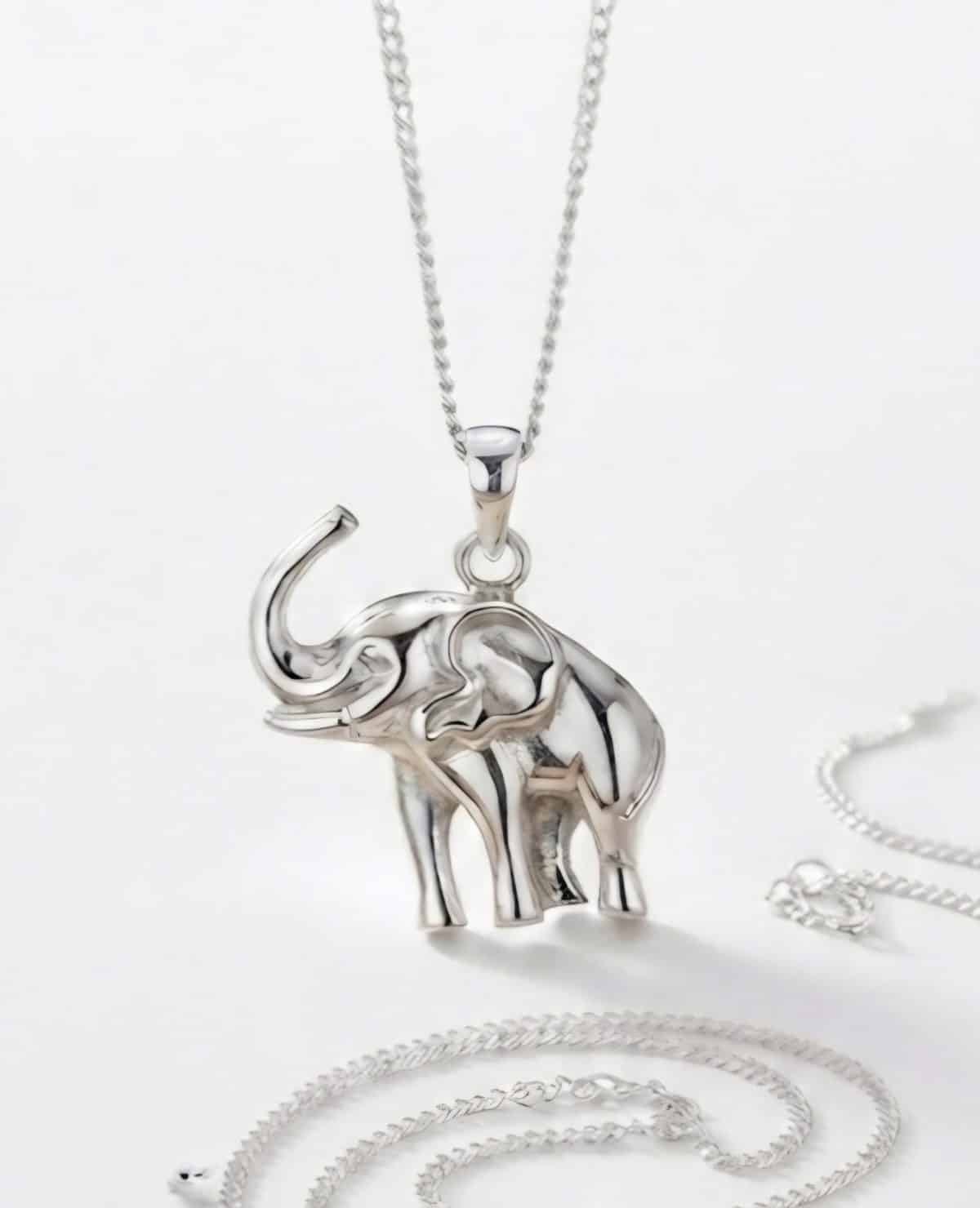 A studio-style product of a sterling silver elephant pandant hanging from a matching silver chain.
