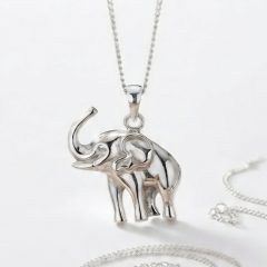 A studio-style product of a sterling silver elephant pandant hanging from a matching silver chain.