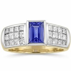 18ct. yellow gold ring with a bezel-set rectangular tanzanite center stone flanked by channel-set princess-cut diamonds. Top of ring is white gold rhodium plated.