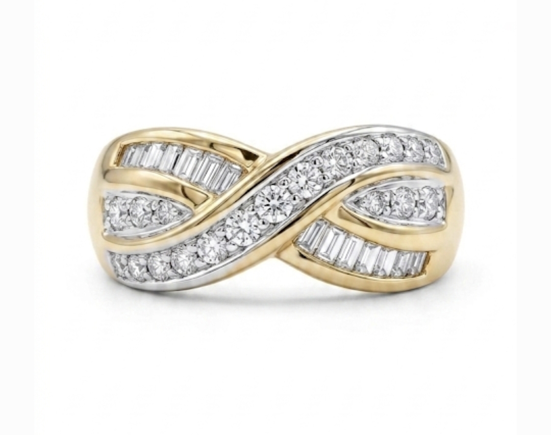 18ct. Yellow Gold crossover ring set with channel-set baguette cut and round brilliant cut diamonds.
