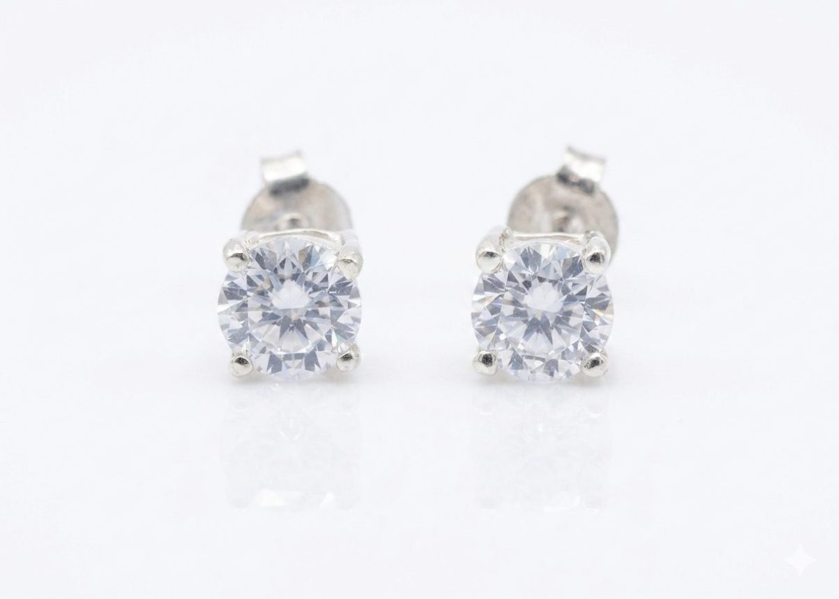 A pair of round-cut cubic zirconia stud earrings set in sterling silver, with push on butterflies.