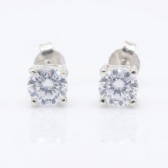 A pair of round-cut cubic zirconia stud earrings set in sterling silver, with push on butterflies.