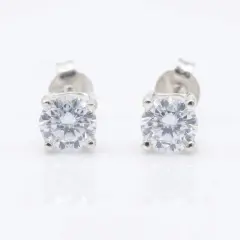 A pair of round-cut cubic zirconia stud earrings set in sterling silver, with push on butterflies.