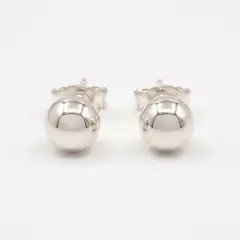 Falda Silver half ball stud earrings, showcasing their polished, reflective metallic surface and simple, elegant design with push on butterflies.