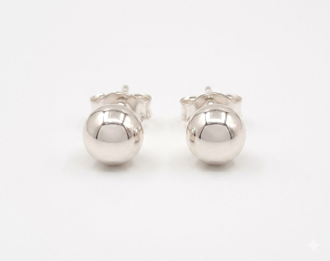 Silver half ball stud earrings, showcasing their polished, reflective metallic surface and simple, elegant design with push on butterflies.