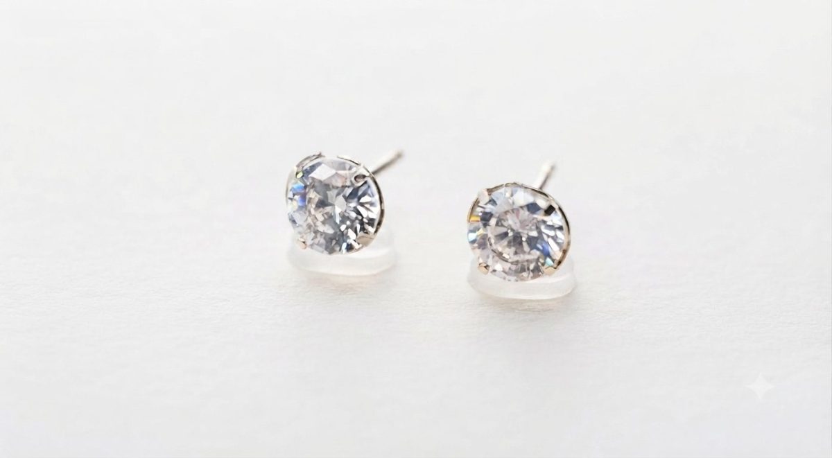 A pair of brilliant - cut cubic zirconia stud earrings set in 9ct white gold with push on butterflies.