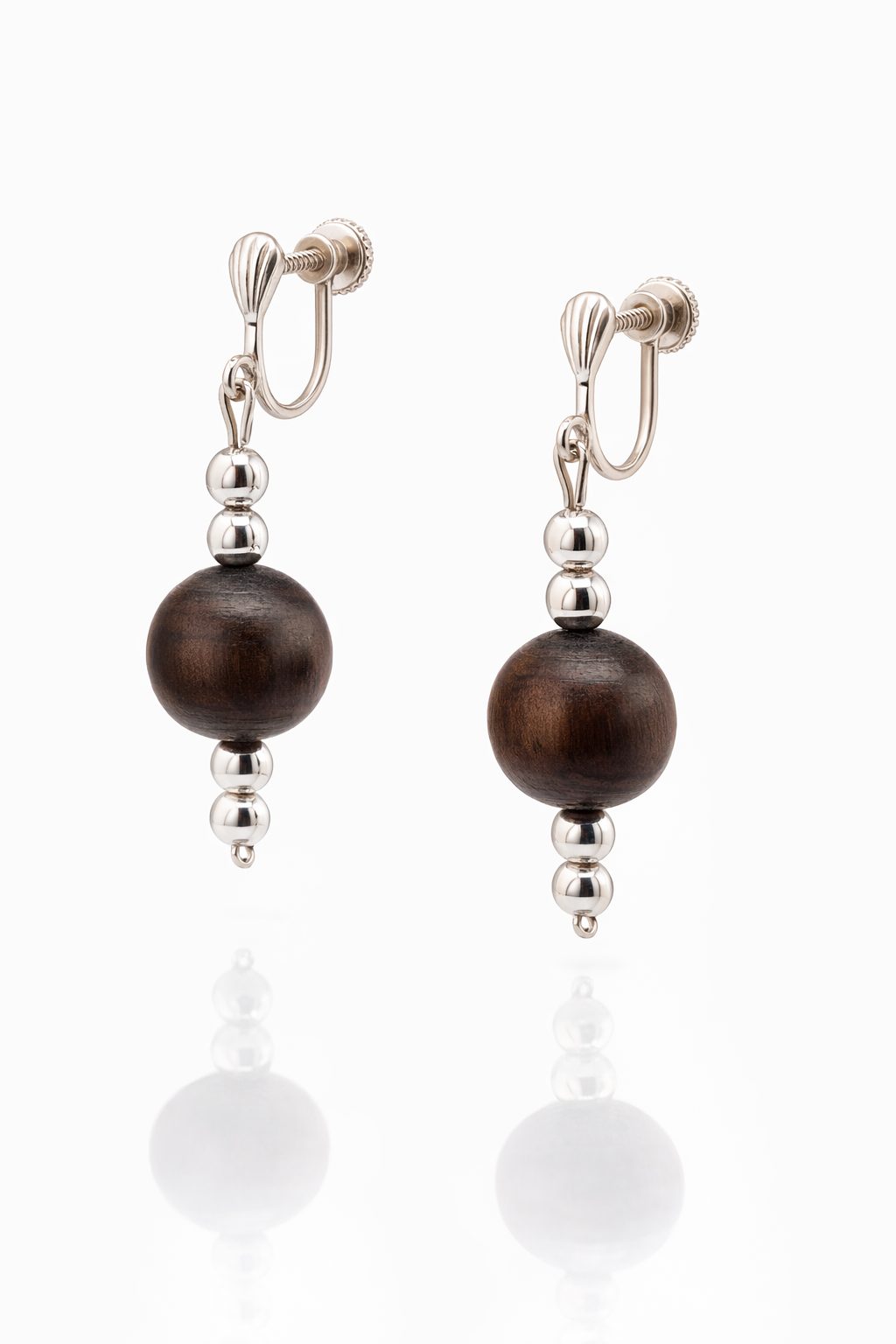 Elegant silver roll‑on earrings featuring polished silver beads and natural dark wood grain balls.