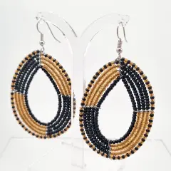 A pair of African beads gold and black colour in an oval shaped dangling with Sheppard hooks