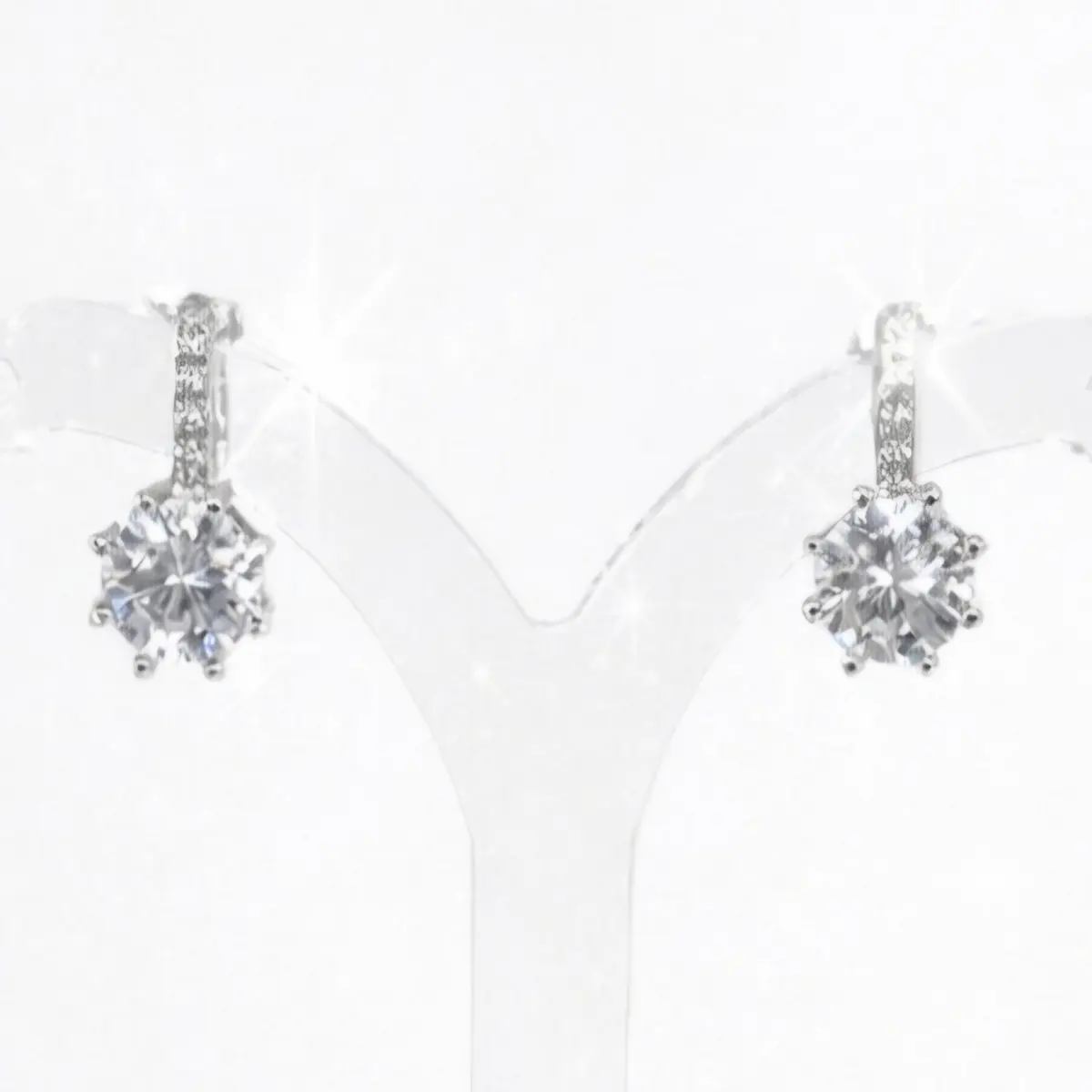 image_1775489552659 Brilliant silver cubic zirconia stud earrings. Each earring features a round brilliant cut CZ stone set in a polished 6 prong silver mount, with small cz on the bar above, stud clip finish.