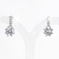 Brilliant silver cubic zirconia stud earrings. Each earring features a round brilliant cut CZ stone set in a polished 6 prong silver mount, with small cz on the bar above, stud clip finish.