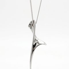 Screenshot_20260602_162608_Google(1) A sleek, abstract silver pendant titled "The Dancer" suspended on a delicate silver chain 44cm long.