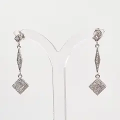 Exquisite 14ct white gold dangling earrings featuring sparkling diamonds with cool, icy brilliance