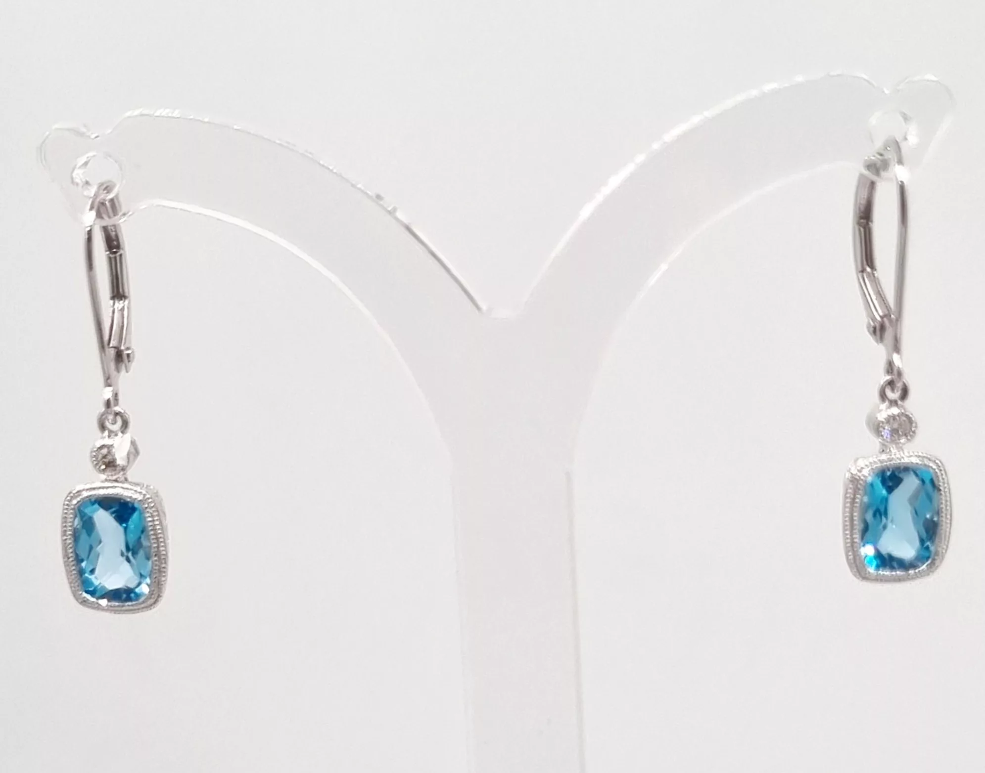 A pair of elegant diamond drop earrings set in white metal.