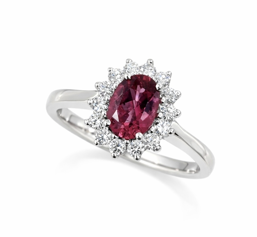 Screenshot_20260504_110306_WhatsApp Elegant 18ct. white gold ring featuring an oval rubellite tourmaline surrounded by a halo of round brilliant-cut diamonds.