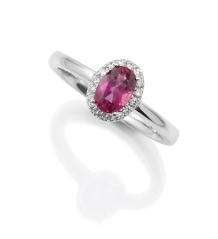 18ct. White Gold Oval Pink Tourmaline, surrounded by a halo of 16 round diamonds of 0.08ct.