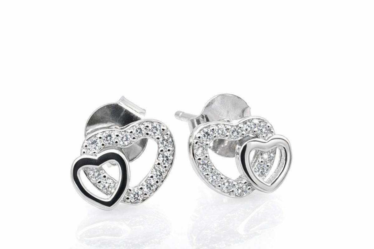 Sterling silver interlocking heart stud earrings featuring one polished heart and one heart encrusted with sparkling cubic zirconia stones.