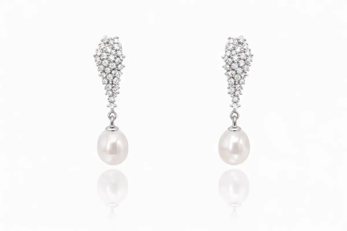 legant sterling silver drop earrings featuring cascading clusters of sparkling cubic zirconia and lustrous white freshwater pearls.
