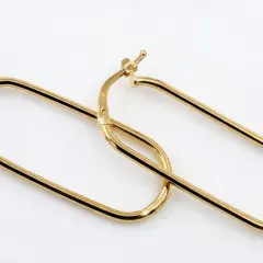 A pair of polished 9ct yellow gold hoop earrings with an elongated, rounded rectangular shape arranged diagonally. Featuring highlighted reflections to emphasize the metallic shine.