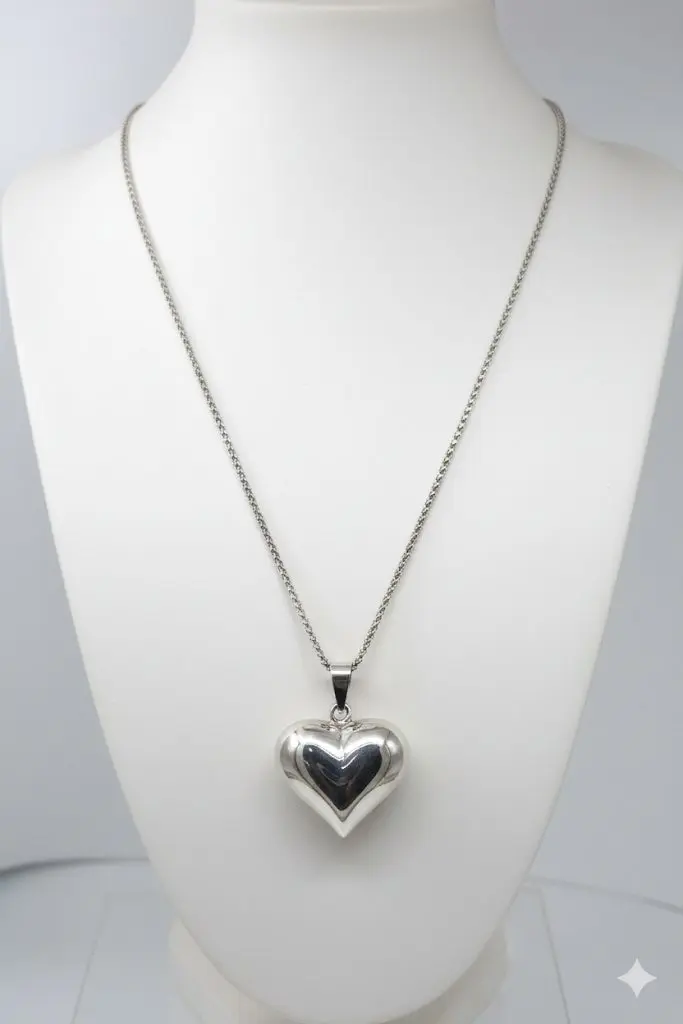Violet Sterling Silver Necklace Sterling silver puffed heart pendant on a white Jewellery mannequin.
