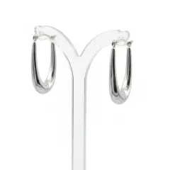 A pair of 9ct white gold teardrop earrings displayed on a clear acrylic stand, shown from a three-quarter side angle against a clean, solid white background.