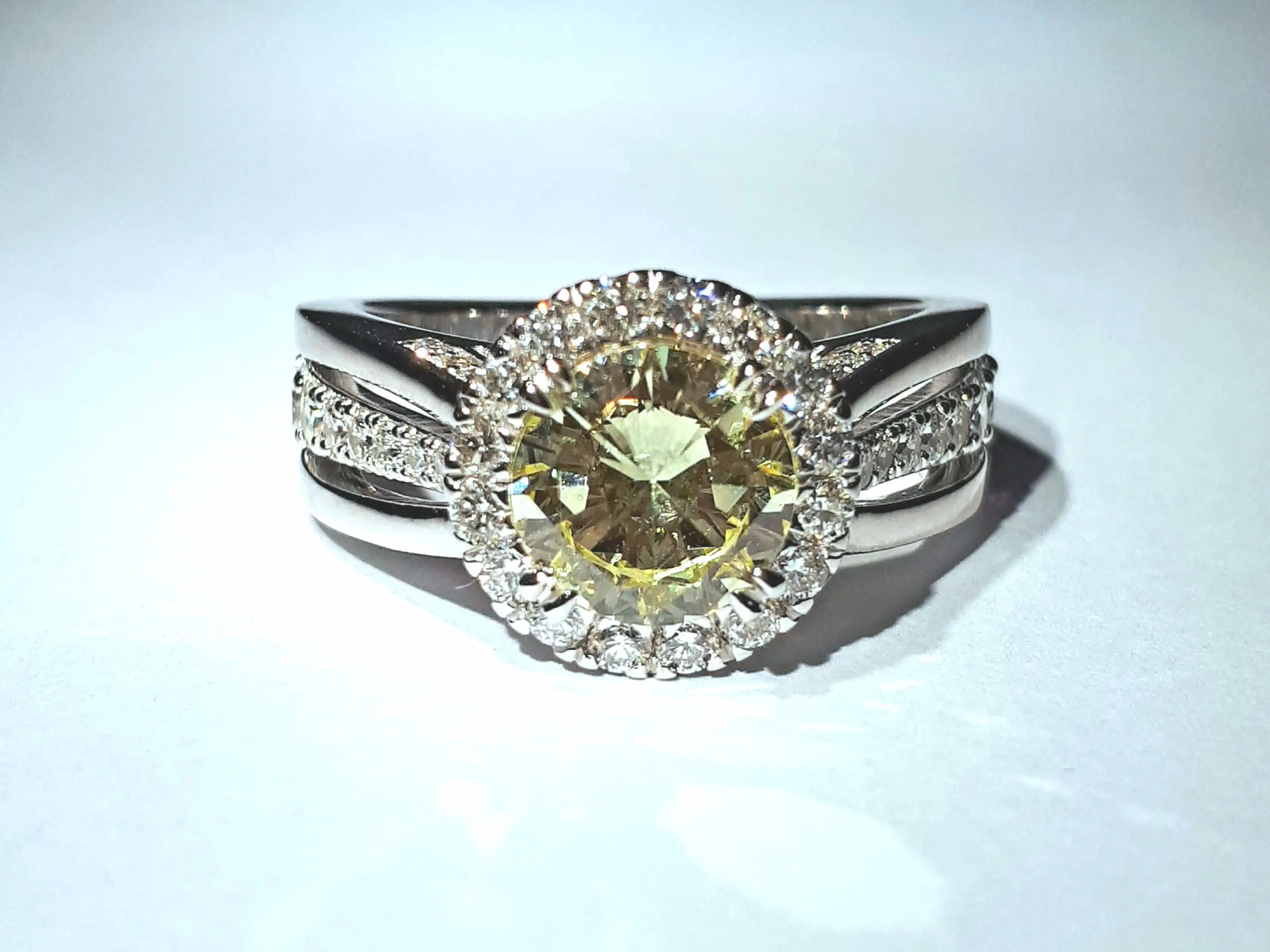 Elegant dress ring display on white background.