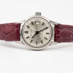 Vintage Doxa ladies automatic watch with a silver sunburst dial, date window, and maroon croc-embossed leather strap.