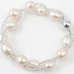Elegant twisted freshwater pearl and crystal bracelet with a silver fish hook clasp, perfect for bridal or formal wear.
