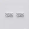 A pair of small, elegant silver infinity symbol earrings set with multiple sparkling Cubic Zirconia, with push on butterflies.