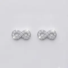 A pair of small, elegant silver infinity symbol earrings set with multiple sparkling Cubic Zirconia, with push on butterflies.
