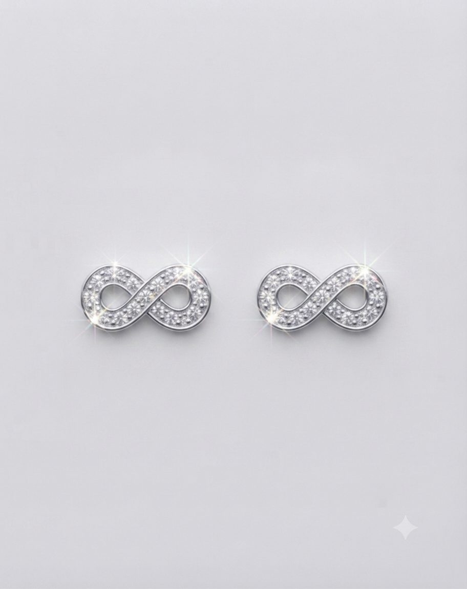 A pair of small, elegant silver infinity symbol earrings set with multiple sparkling Cubic Zirconia, with push on butterflies.