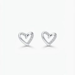 A pair of polished silver heart-shaped stud earrings featuring small cubic zirconia along one side of the heart, with push on butterflies.